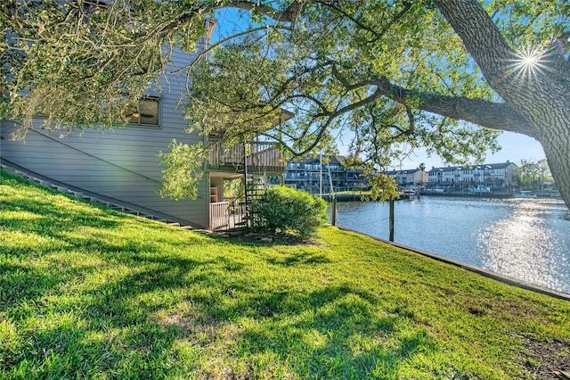 view of yard featuring stairway and a water view