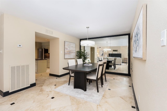 dining space featuring visible vents and baseboards