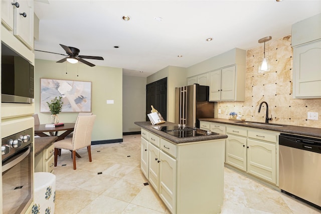 kitchen with a center island, decorative light fixtures, stainless steel appliances, dark countertops, and a sink