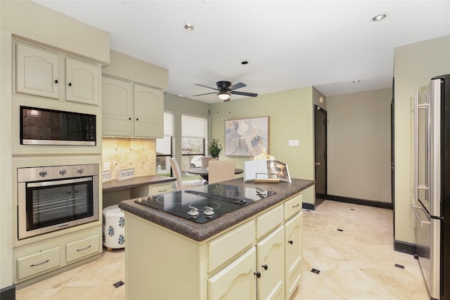 18138 Bal Harbour Dr, Houston, TX 77058 - kitchen with stainless steel appliances, cream cabinets, dark countertops, a ceiling fan, and a center island
