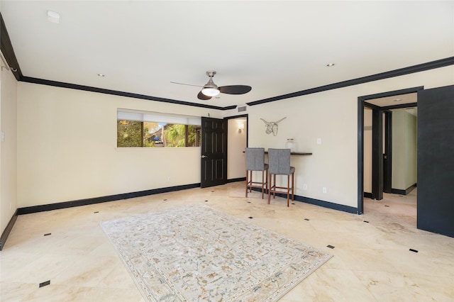 empty room with crown molding, ceiling fan, visible vents, and baseboards