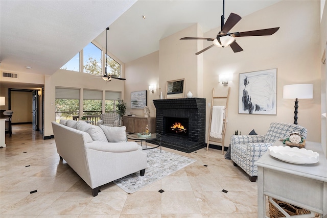 living room with ceiling fan, high vaulted ceiling, a fireplace, and visible vents