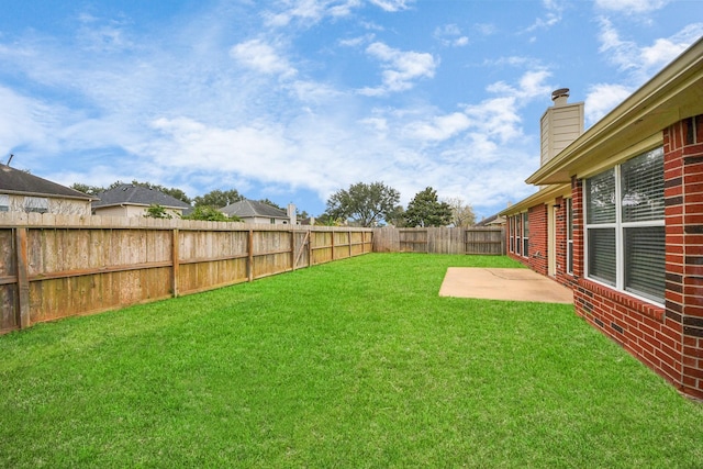 view of yard featuring a patio and a fenced backyard