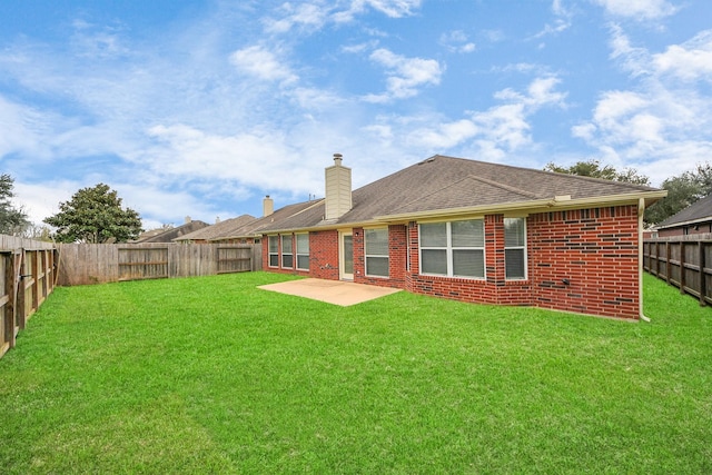 back of property featuring a patio area, a fenced backyard, a lawn, and brick siding