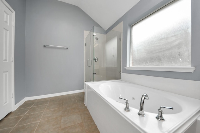 bathroom featuring vaulted ceiling, a shower stall, tile patterned flooring, baseboards, and a bath