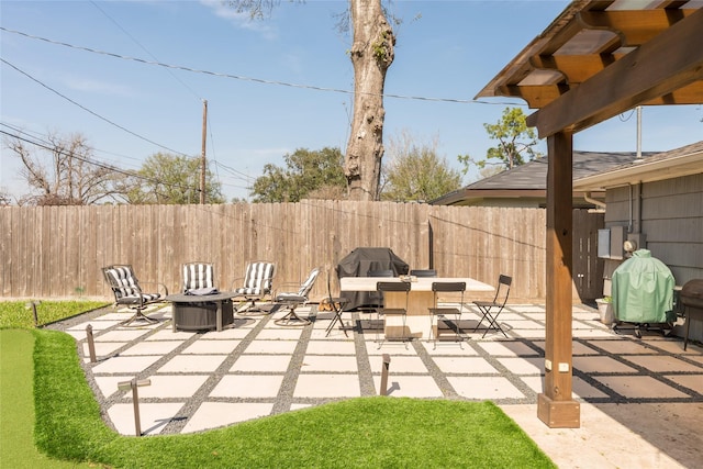 view of patio / terrace with area for grilling and a fire pit