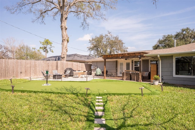 view of yard featuring an outdoor fire pit, ceiling fan, and a patio area