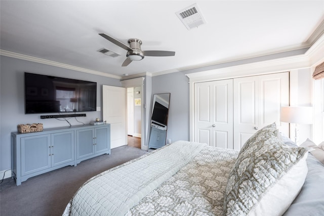 bedroom with a closet, dark colored carpet, crown molding, and ceiling fan