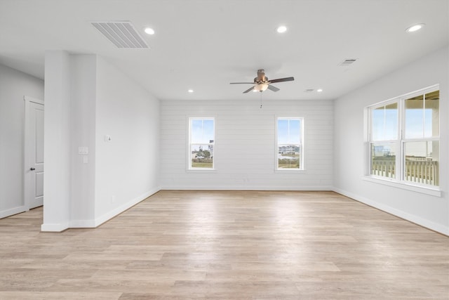 spare room featuring light hardwood / wood-style floors, plenty of natural light, and ceiling fan