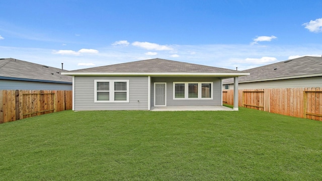 back of house featuring a fenced backyard, a yard, and a patio
