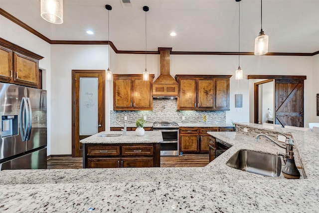 kitchen featuring a sink, stainless steel appliances, pendant lighting, and light stone counters