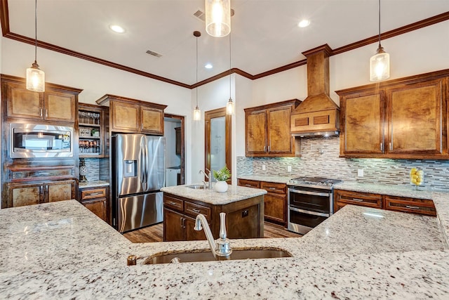 kitchen with light stone countertops, pendant lighting, custom exhaust hood, and appliances with stainless steel finishes