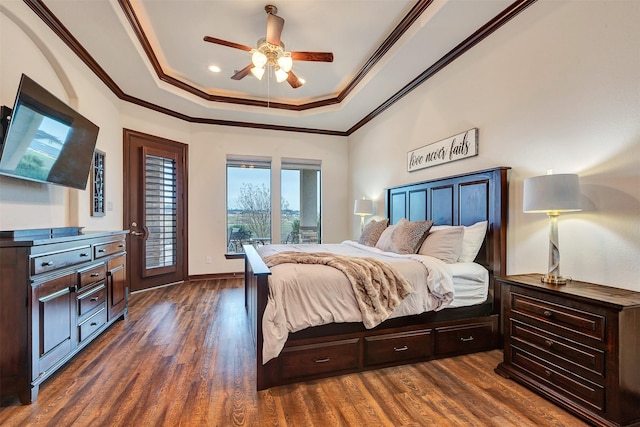 bedroom with access to exterior, a tray ceiling, crown molding, a ceiling fan, and dark wood-type flooring