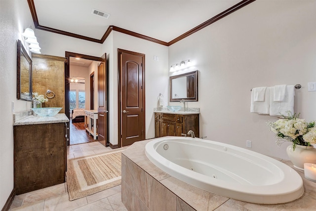 full bathroom with a jetted tub, crown molding, visible vents, and vanity