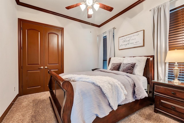 bedroom with a closet, ceiling fan, light carpet, baseboards, and crown molding