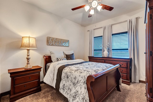 carpeted bedroom featuring baseboards and a ceiling fan