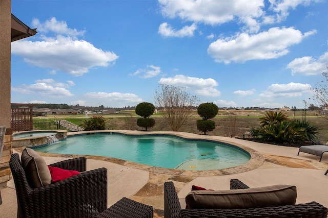 view of swimming pool featuring a pool with connected hot tub and a patio