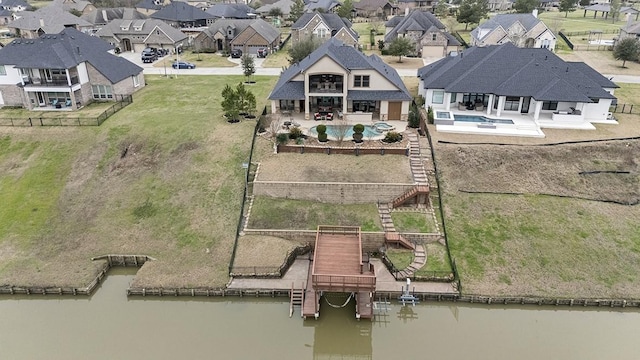 birds eye view of property featuring a water view and a residential view