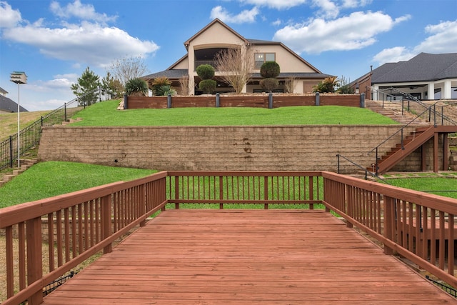 deck with a yard and fence