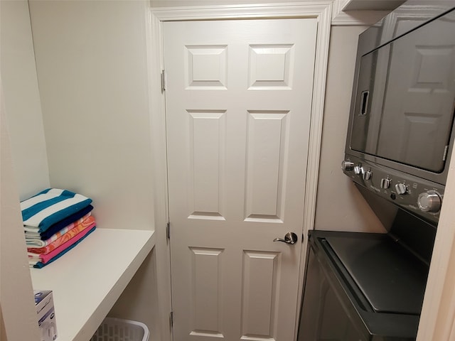 clothes washing area with stacked washer / dryer and laundry area