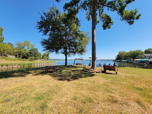 view of yard featuring a water view and fence