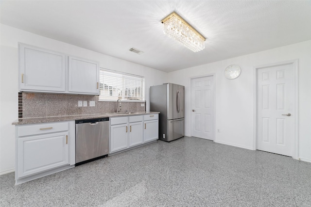 kitchen with white cabinetry, appliances with stainless steel finishes, sink, and tasteful backsplash