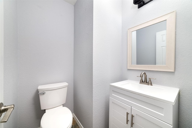 bathroom with toilet and vanity