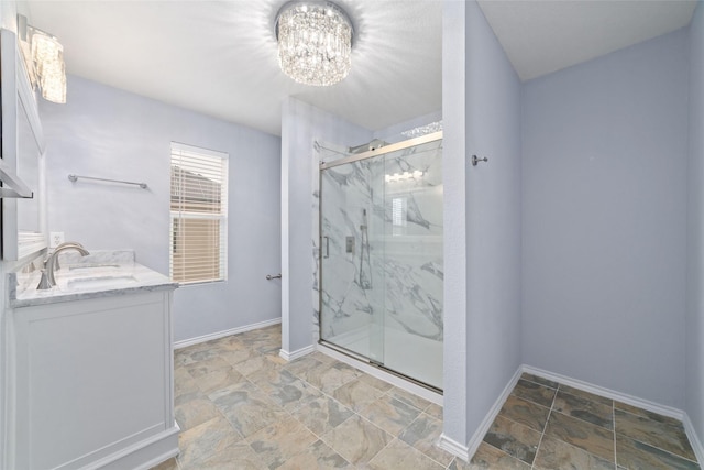 bathroom featuring an enclosed shower, a chandelier, and vanity