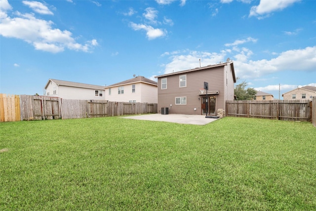 rear view of house featuring a patio area, a yard, and central air condition unit