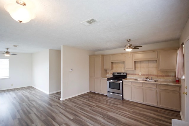 8030 Lawler St, Houston, TX 77051 - kitchen with sink, tasteful backsplash, stainless steel electric stove, a textured ceiling, and hardwood / wood-style floors