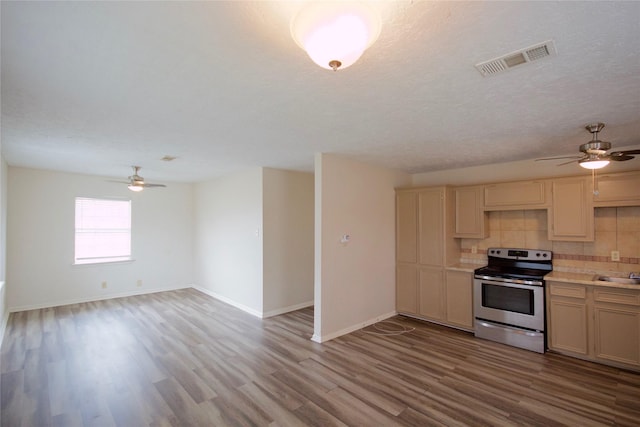 8030 Lawler St, Houston, TX 77051 - kitchen with sink, backsplash, electric range, a textured ceiling, and light hardwood / wood-style flooring