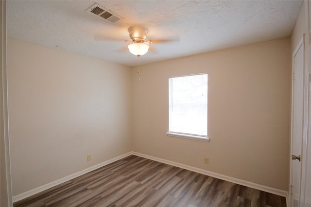 8030 Lawler St, Houston, TX 77051 - empty room featuring dark hardwood / wood-style floors, a textured ceiling, and ceiling fan