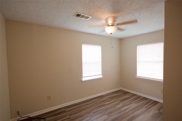 8030 Lawler St, Houston, TX 77051 - empty room featuring a textured ceiling, ceiling fan, and wood-type flooring