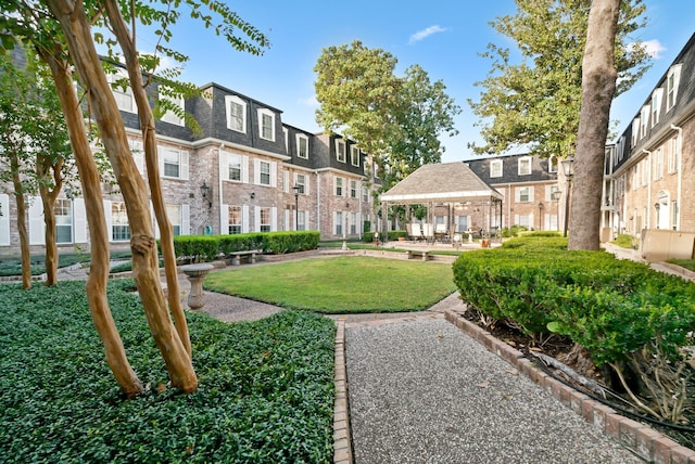 view of property's community with a lawn