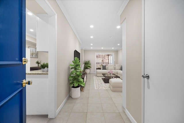 hall featuring light tile patterned flooring and crown molding