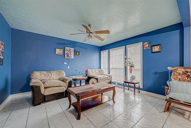 tiled living room featuring a textured ceiling and ceiling fan