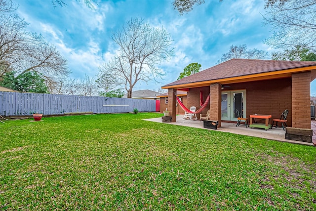 view of yard featuring a patio area and french doors