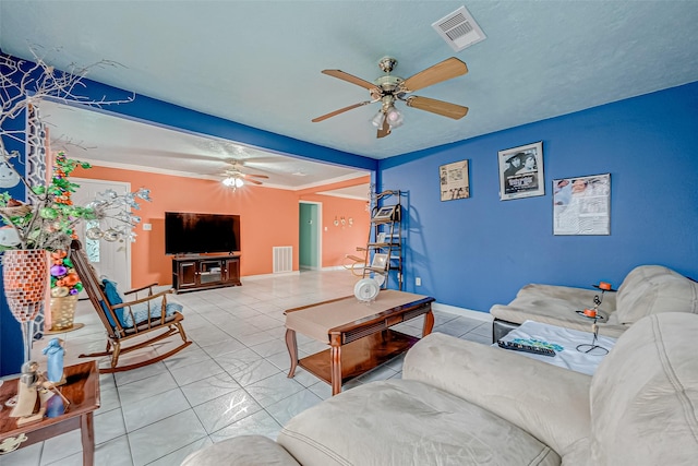 living room featuring ornamental molding, ceiling fan, and tile patterned flooring