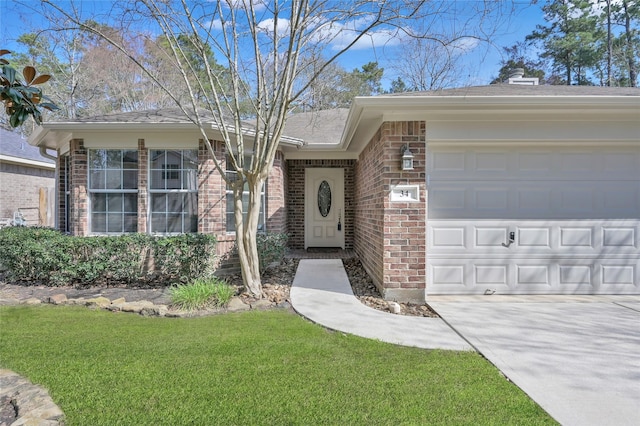 doorway to property featuring a yard and a garage