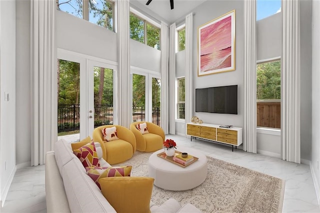 sunroom with french doors and a ceiling fan