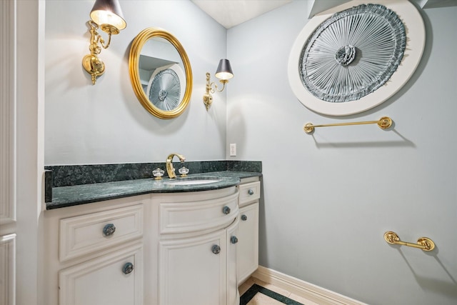 bathroom with vanity and baseboards