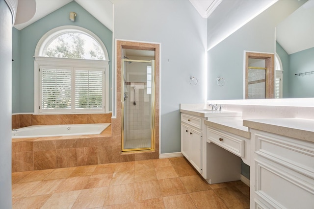 full bath with a garden tub, vaulted ceiling, a shower stall, and vanity