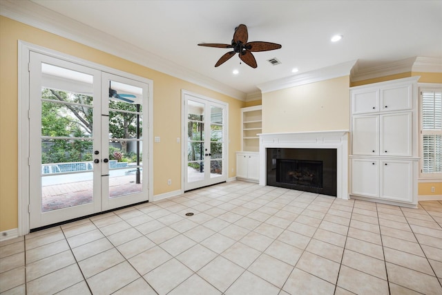 unfurnished living room featuring visible vents, baseboards, ornamental molding, french doors, and a fireplace