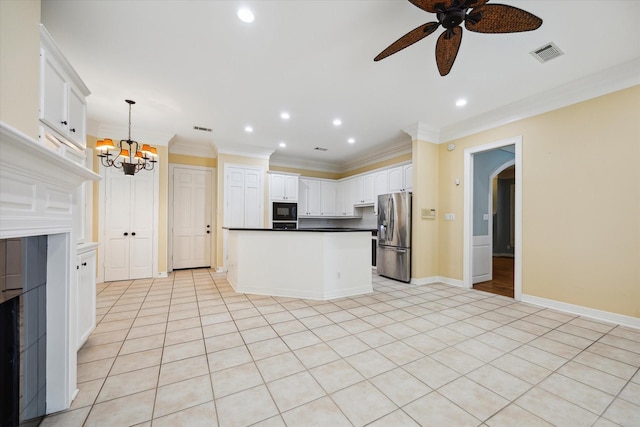 kitchen with black microwave, visible vents, white cabinets, hanging light fixtures, and stainless steel fridge with ice dispenser