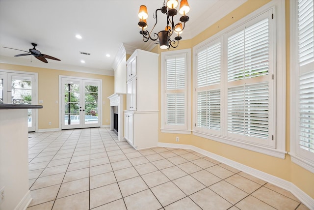 kitchen featuring a fireplace, visible vents, hanging light fixtures, ornamental molding, and white cabinetry