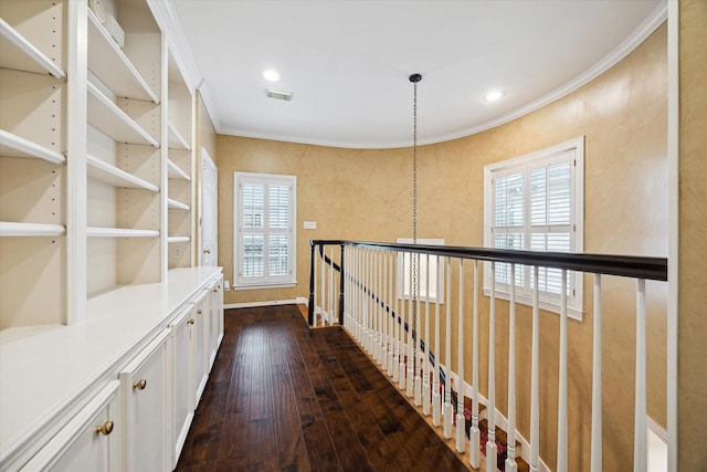 hallway with visible vents, dark wood-type flooring, crown molding, and recessed lighting