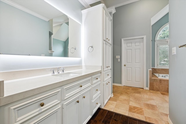 full bathroom with baseboards, vanity, a bath, and crown molding