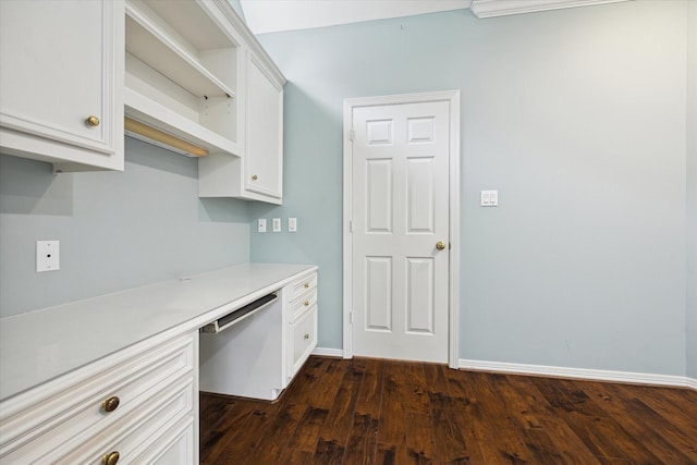 kitchen with white cabinets, dishwasher, built in study area, light countertops, and open shelves