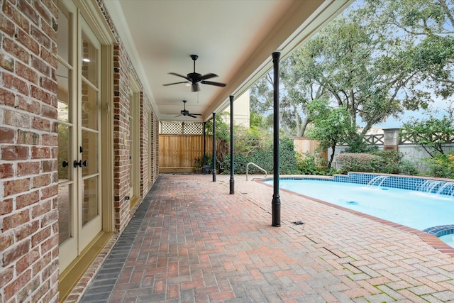 view of patio featuring a fenced backyard, ceiling fan, a fenced in pool, and french doors