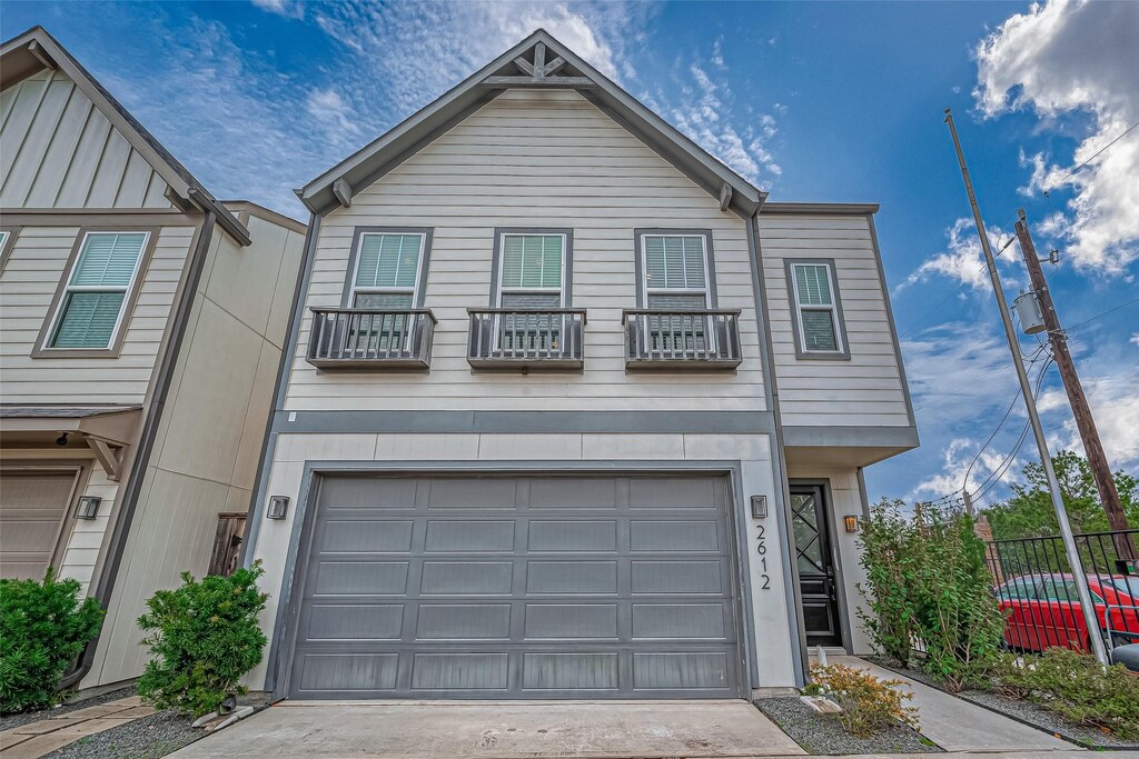 2612 W Tidwell Rd, Houston, TX 77091 - view of front of home featuring a garage and concrete driveway